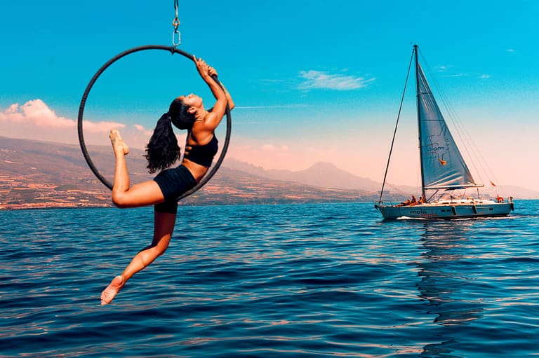 A woman doing aerial hoop over the sea